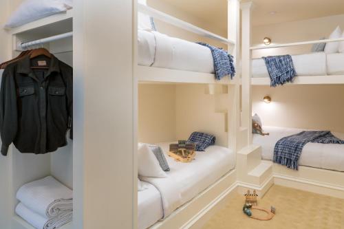 a room with two bunk beds with white shelves at Bohemia Manor Farm in Chesapeake City