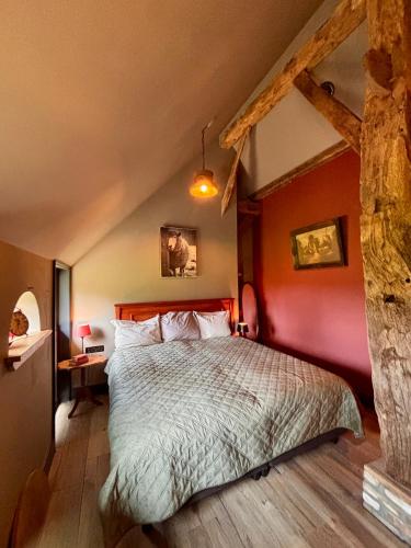 a bedroom with a large bed in an attic at De Oranjehoeve in Holthone