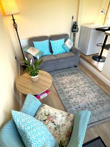 a living room with a couch and a table at La Mer self-catering in Sark