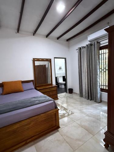 a bedroom with a bed and a mirror at Niwasa Habarana in Habarana