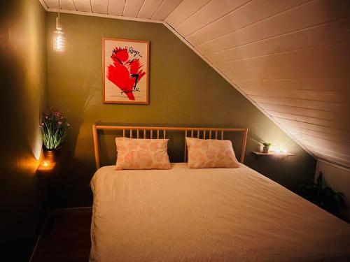 a bedroom with a bed with two pillows at Penthouse in Farsund in Farsund