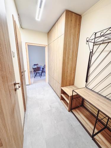 a hallway of a house with a staircase and a table at Kodó Apartman in Székesfehérvár