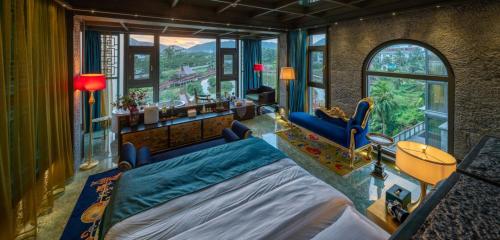 a bedroom with a bed and a room with a view at Zishui Qinglu Manor in Sanya