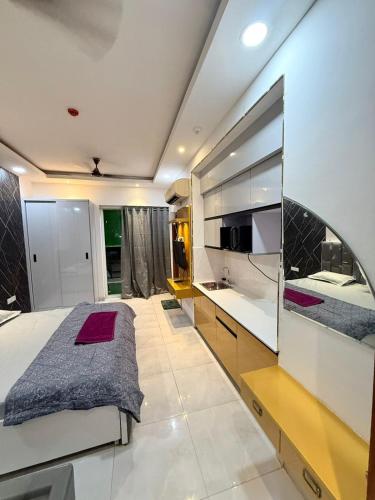 a bedroom with a large bed and a large mirror at Aayu's Home 74 in Noida