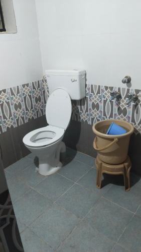 a bathroom with a toilet and a bidet at Avani homestay in Subrahmanya