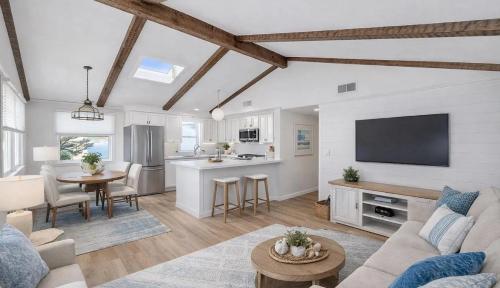 a living room with a couch and a table and a kitchen at Mermaid Manor in Brighton Beach