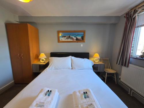 a bedroom with a large bed with two trays on it at Mount Lavinia in Sheringham