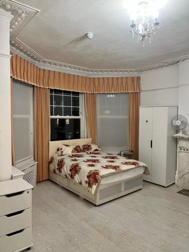 a bedroom with a large bed and a window at Caterine lodge in Whetstone