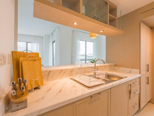 a kitchen with a sink and a counter at the 'Byron Bay' Condo - Coastal 2BR - Executive Burj Khalifa Suite in Dubai