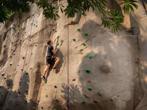 a man is on a rock climbing wall at Mercure Pattaya Ocean Resort in Pattaya