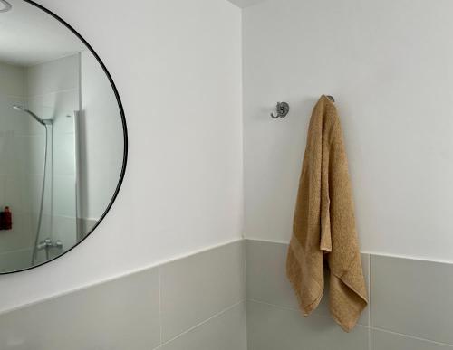 a bathroom with a mirror and a towel at Canaryislandshost l Balcón del Mar in Puerto del Carmen