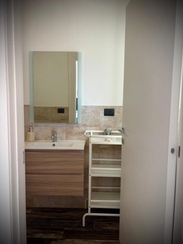 a bathroom with a sink and a mirror at B&B Helios in Nardò