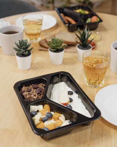 a tray of food on a wooden table with snacks at Kamienica Parkowa in Dąbki