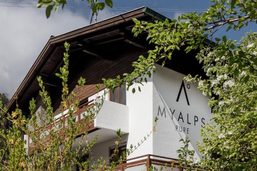 a sign on the side of a building with trees at MYALPS Pure in Oetz
