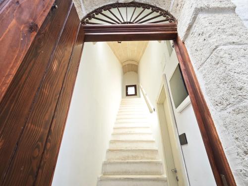 a stairway leading up to a building with a wooden door at Azzurro A Mare in Polignano a Mare