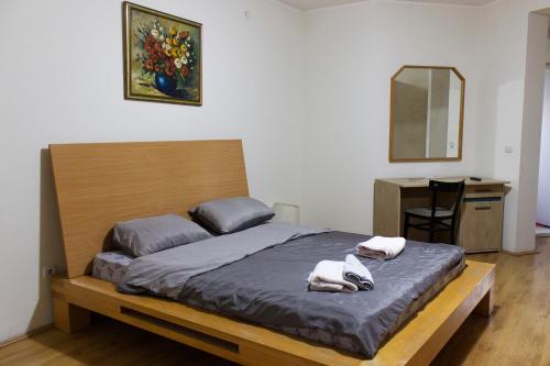 a bedroom with a bed with two towels on it at Casa & Spa Medison in Zrenjanin