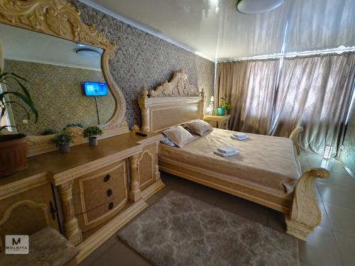a bedroom with a bed and a large mirror at Rassvet in Lenīnogorsk