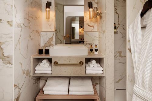 a bathroom with a sink and a mirror at Montcalm Mayfair, Autograph Collection in London