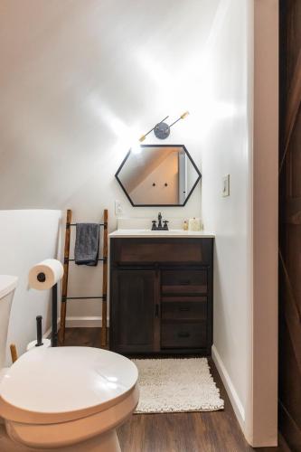 a bathroom with a toilet and a sink at Private Fire Pit Pool Table Barry Manor in Barryville
