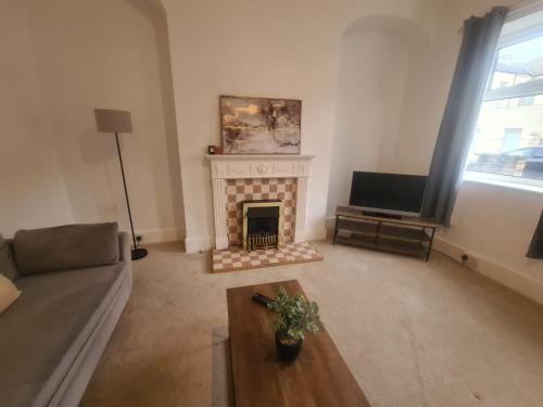 a living room with a fireplace and a television at Blyth 1 Bedroom Apartment in Blythe