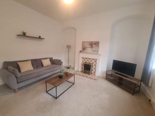 a living room with a couch and a fireplace at Blyth 1 Bedroom Apartment in Blythe