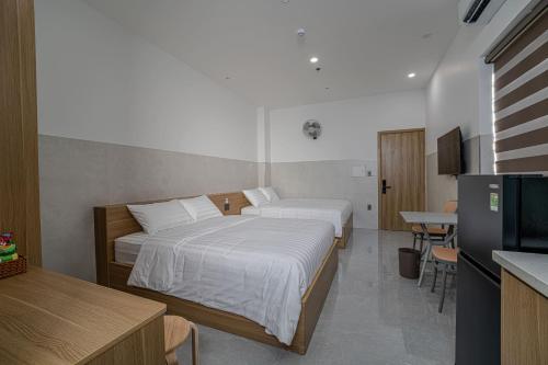 a hotel room with two beds and a television at An Thy HOTEL in Vung Tau