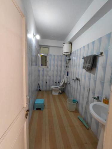 a bathroom with a toilet and a sink at Indu Homestay in Shimla