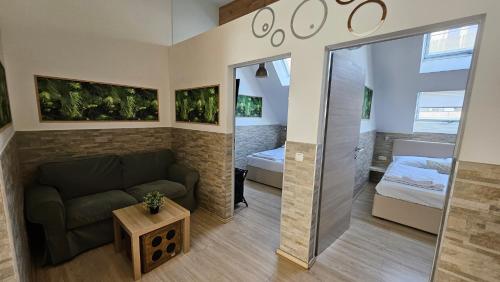 a living room with a couch and a bedroom at Flatprovider - Manuela Apartment Vienna in Vienna