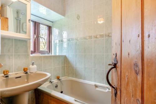 a bathroom with a bath tub and a sink at 2 Bed in Clitheroe oc-la156 in Harrop Fold