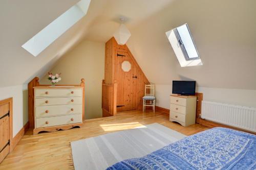 a bedroom with a bed and a dresser and a window at 1 Bed in Bergh Apton oc-1387 in Thurton