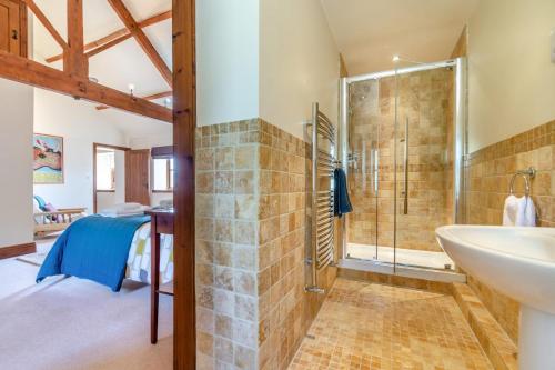 a bathroom with a tub and a shower and a sink at 2 Bed in Thwing oc-t29012 in Thwing