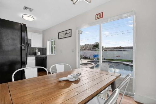 a kitchen and dining room with a wooden table and chairs at Home at Boulevard Heights, Hollywood in Hollywood