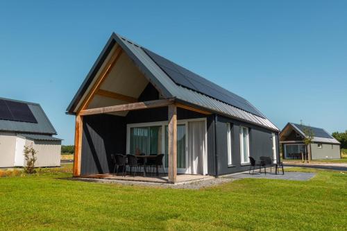 a large black house with a black roof at EuroParcs Cadzand-Bad in Cadzand