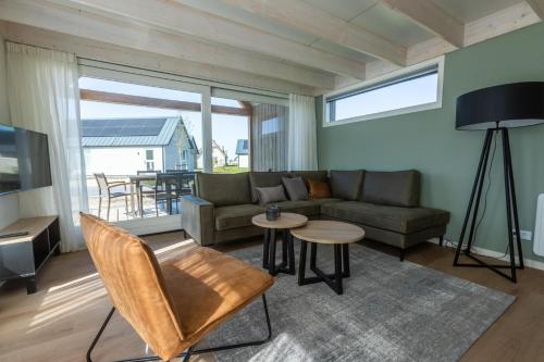 a living room with a couch and a table at EuroParcs Cadzand-Bad in Cadzand