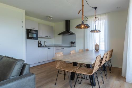 a kitchen and dining room with a table and chairs at EuroParcs Cadzand-Bad in Cadzand