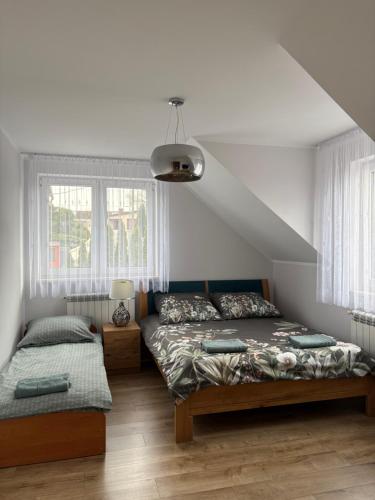 a bedroom with two beds and a window at Biebrzańska Dolina 1 in Goniadz