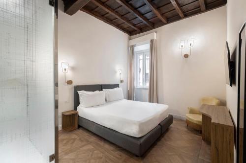a bedroom with a white bed and a window at 19 Steps Trevi in Rome