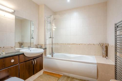 a bathroom with a tub and a sink and a bath tub at 2 Bed in Whitby oc-h31801 in Whitby