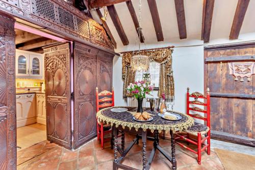 a dining room with a table and red chairs at 1 Bed in Long Bennington oc-t29871 in Long Bennington