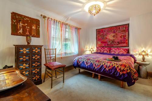 a bedroom with a bed and a table and a chair at 4 Bed in Long Bennington oc-p29872 in Long Bennington