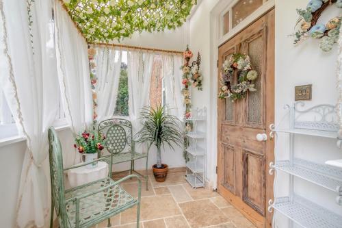 a room with a door and a chair and a window at 4 Bed in Long Bennington oc-p29872 in Long Bennington