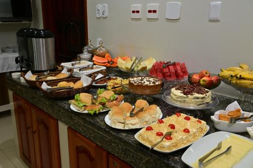 a buffet with many different types of food on a counter at Frota Palace Hotel in Macapá