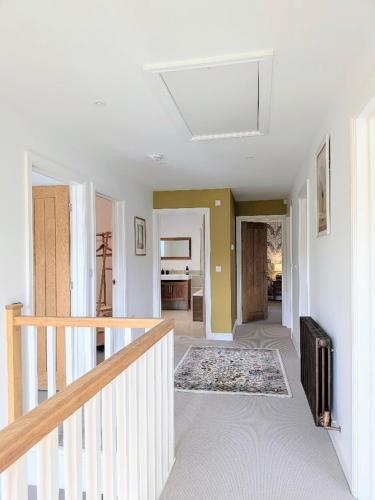 a hallway with a staircase in a home at Coastal Whisper Sleeps 10 with Parking in Reighton