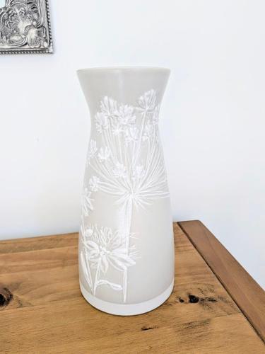 a white vase sitting on top of a wooden table at Coastal Whisper Sleeps 10 with Parking in Reighton