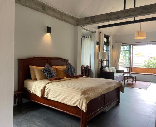 a bedroom with a bed and a living room at Palin Family Cottage in Chiang Rai