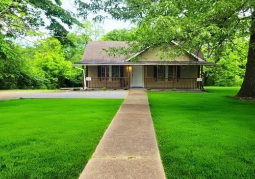 a small house with a green lawn in front of it at Red Bud in Chattanooga