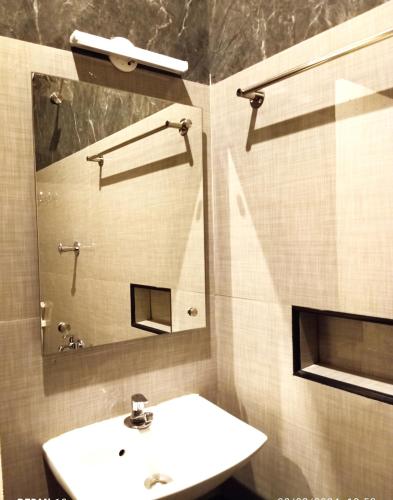 a bathroom with a sink and a mirror at Hotel ELITE Rameswaram in Rāmeswaram