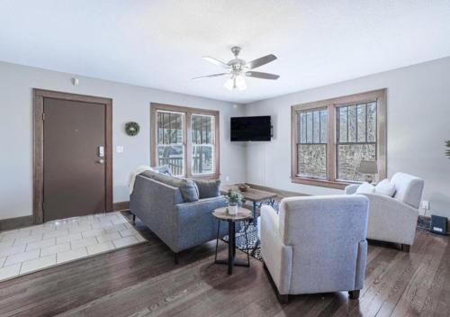 a living room with chairs and a ceiling fan at Red Bud in Chattanooga