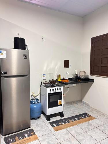a kitchen with a refrigerator and a stove at Apartamento Barbosa in Santarém