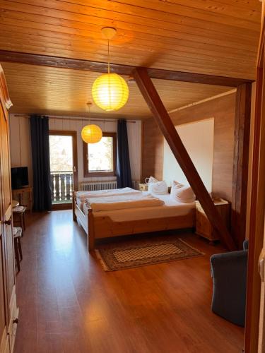 a bedroom with a bed in a room with wooden ceilings at Hotel Maien in Todtmoos
